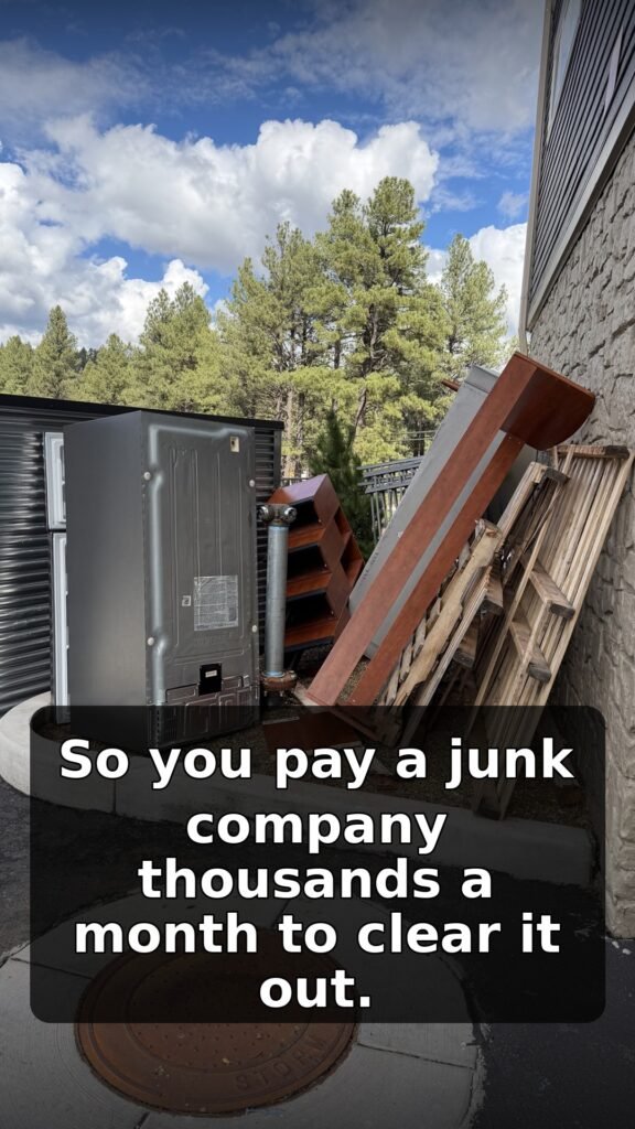 Refrigerator, shelving and pallets left beside an apartment trash enclosure in Flagstaff